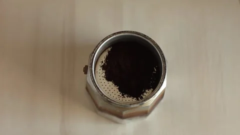 Close-up of a hand pouring coffee into a geyser coffee maker. Stock Footage 281857005