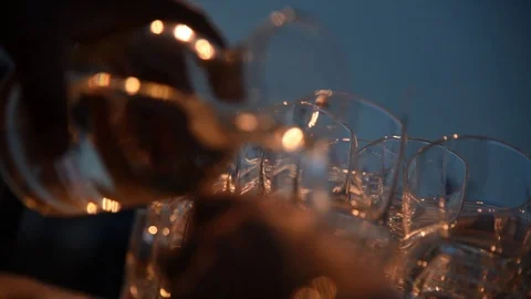 Close-Up Of Hand Pouring Vodka From A Bottle Into A Glass, Slow Motion Stock Footage 112250585