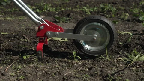 A close-up of a hand-powered harrow Stock Footage 219795447