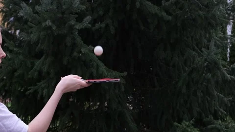 Close-up of a hand practicing table tennis with a red paddle Stock Footage 328421031