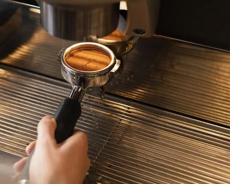 Close up hand preparing coffee with machine. High quality beautiful photo c.. Stock-Fotos