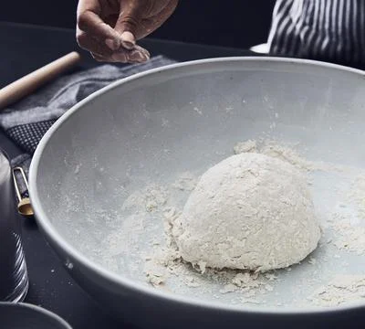 Close-Up of Hand Preparing Dough in Mixing Bowl Stock Photos