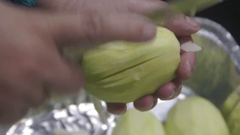 Close-up of hand preparing, peeling, cutting and slicing mango. Stock Footage 97679076