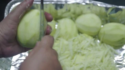 Close-up of hand preparing, peeling, cutting and slicing mango. Stock Footage 97689407
