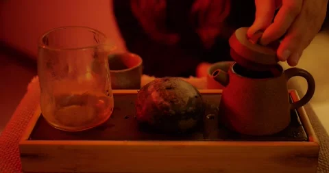 Close-up of a hand preparing tea, touching the teapot lid... Stock Footage 319883363