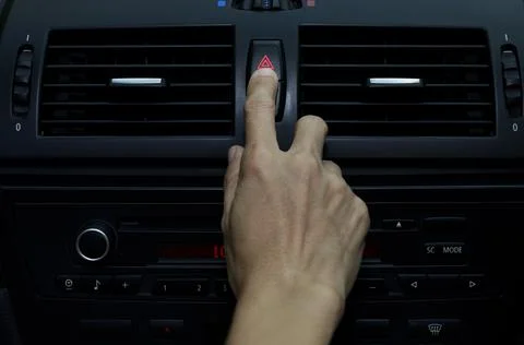Close up hand press the emergency light in the car, Fingers press button.for  Stock Photos