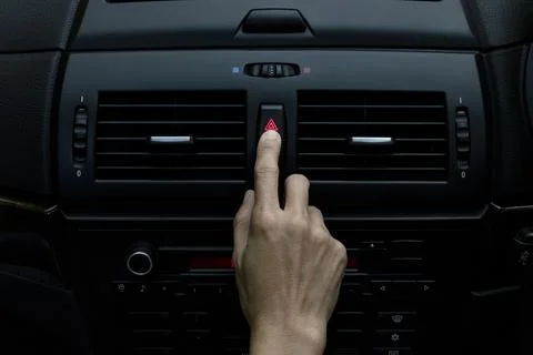 Close up hand press the emergency light in the car, Fingers press button.for  Stock Photos