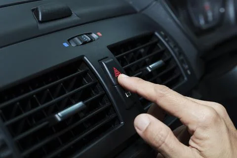 Close up hand press the emergency light in the car, Fingers press button.for  Stock Photos