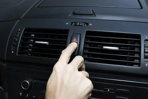 Close up hand press the emergency light in the car, Fingers press button.for  Stock Photos