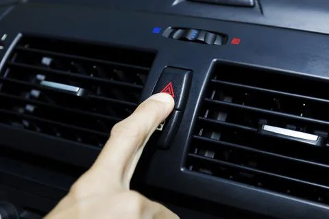 Close up hand press the emergency light in the car, Fingers press button.for  Stock Photos