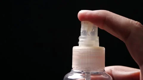 Close-up of Hand presses a button and spray in slow motion Stock Footage 144514894