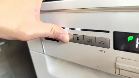 Close up of hand pressing button on dishwasher control panel, selecting washing Stock Footage 337104542