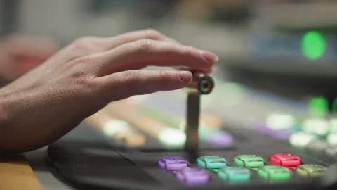 Close-up hand pressing button on television broadcast control panel Stock Footage 317539782