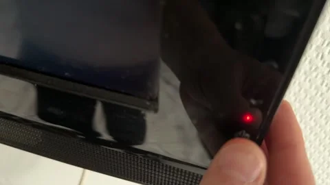 Close up of hand pressing button on television frame, turning on screen, modern 動画素材 337104891