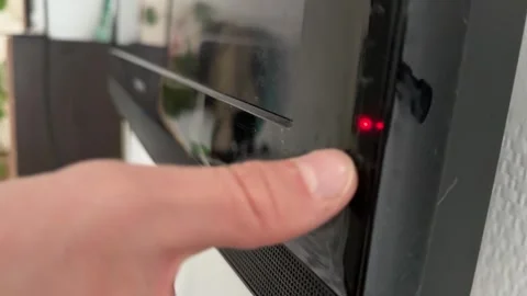 Close up of hand pressing button on television frame, turning on screen, modern 動画素材 337104908