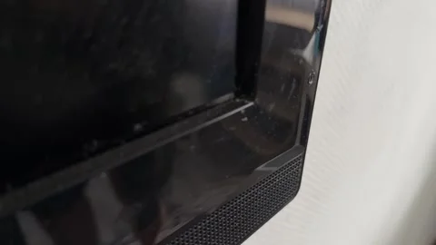Close up of hand pressing button on television frame, turning on screen, modern 動画素材 337104909