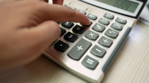 Close-up of a hand pressing buttons on a calculator Stock Footage 320724868