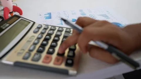 Close-up of a hand pressing buttons on a calculator Stock Footage 320724895