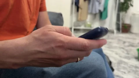 Close-up of hand pressing buttons on an old push-button mobile phone. Retro 動画素材 336524157
