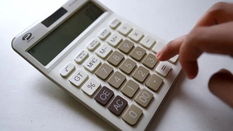 Close-up of a hand pressing buttons on a white calculator Stock Footage 317737004