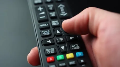 Close-up of a hand pressing the center OK Select button on a TV remote Stock Footage 328974638