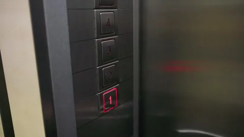Close-up of hand pressing elevator button on metal panel. Focus on finger Stock Footage 306497470