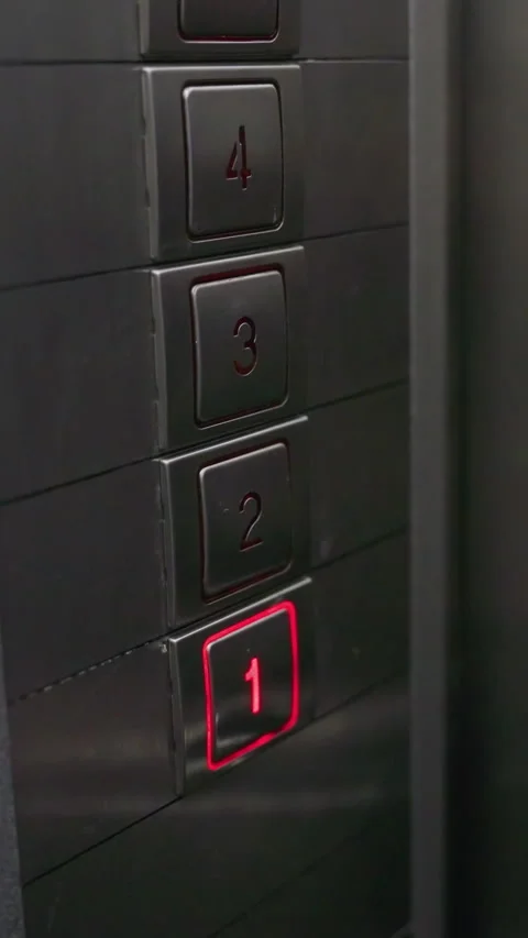 Close-up of hand pressing elevator button on metal panel. Focus on finger Stock Footage 318807289