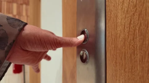 Close-Up Of Hand Pressing Modern Elevator Buttons On Wooden Panel In Lobby Stock Footage 342303472
