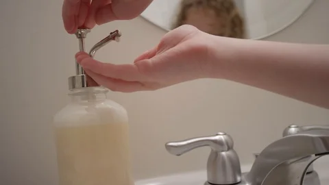 Close up of hand pressing out liquid hand soap in slow motion Stock Footage 128918873