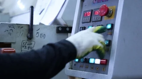 Close-up of hand pressing the red button on the desktop control panel, CNC Stock Footage 73734636
