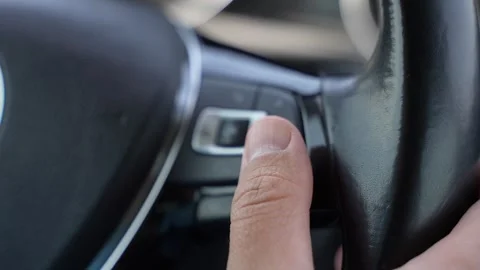 Close Up of Hand Pressing Steering Wheel Button While Driving Vídeos de archivo 341293081