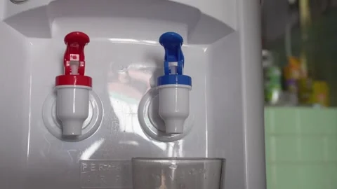 Close up of hand pressing a tap on a water dispenser machine Video stock 337761143