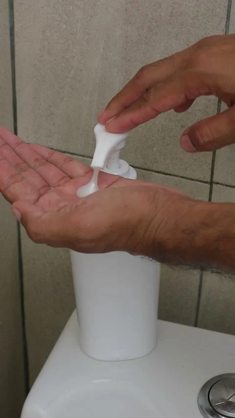 Close up hand pressing white soap dispenser pump for hand washing Stock Footage 333377791