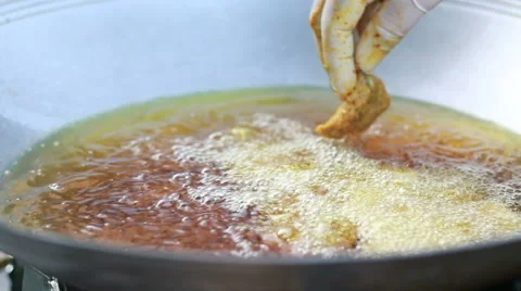 Close up hand Process of cooking fish cakes. Cooking in a wok, deep fry pan Stock Footage 62235379