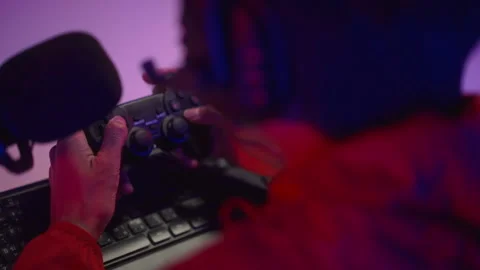 Close up hand of Professional Streamer playing game with joystick online in dark Stock Footage 235653886