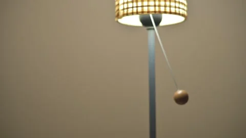 Close-Up Of A Hand Pulling The Cord On A Warm Desk Lamp With A Woven Lampshade Stock Footage 327957307
