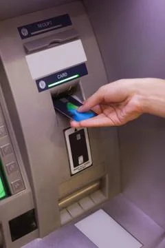 Close up of hand pulling in debit card Stock Photos