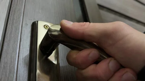 Close up of hand pulling door handle, testing or opening door, everyday Stock Footage 337110408
