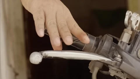 Close-up hand pulling motorcycle front brake lever Stock Footage 320129559