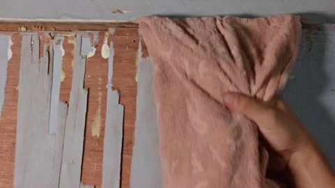 Close Up of Hand Pulling an Orange Towel Stuck Between Old Wooden Door Frames 스톡 동영상 335138630