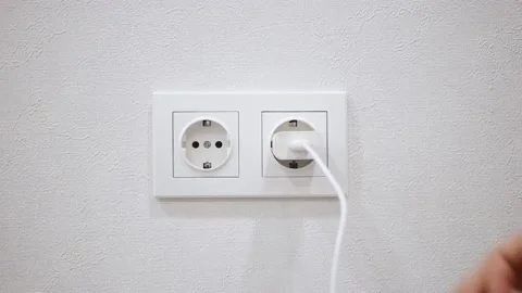 Close-up of hand pulling out white power adapter with USB Video stock 150331916