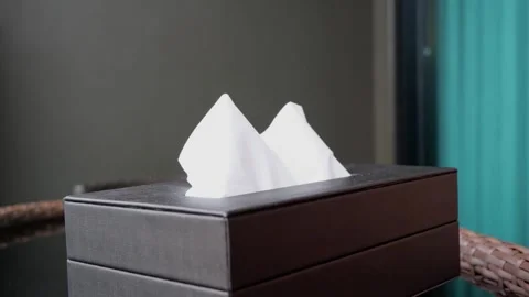 Close up of hand pulling tissue from black box 库存影片 345944775