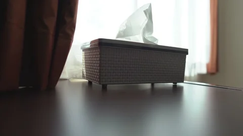 Close up hand pulling tissue paper in box on table, beside window bright light Video stock 122883439