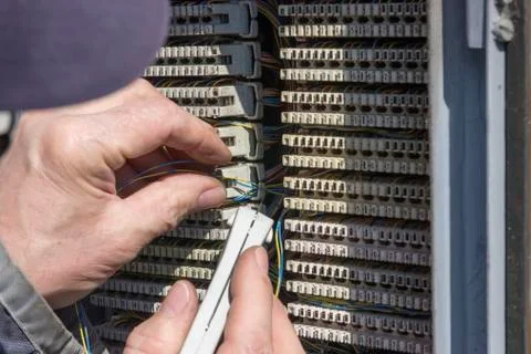 Close of hand punching down circuit panel Stock Photos