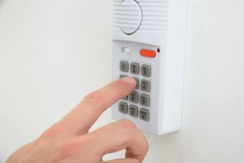 Close-up Of A Hand Pushing Button On Security System Stock Photos