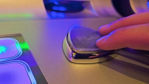 Close-up of a hand pushing the chrome play button on a casino slot machine Stock Footage 345809914