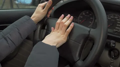 Close up of hand pushing horn on steering wheel when driving. Stock Footage 144079824