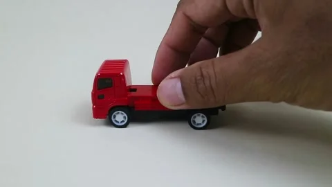 Close Up Hand Pushing Small Red Toy Truck Stock Footage 334941594