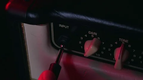 Close up of Hand Put in Aux and adjust Gain Button of Amplifier 動画素材 124086366