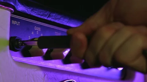 Close up of Hand Put in the Aux Cable in Amplifier Stock Footage 123858064